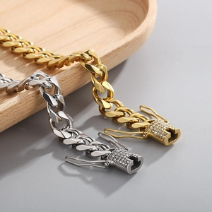 Men's gold and silver Cuban link bracelets with iced out rhinestone clasps on wood