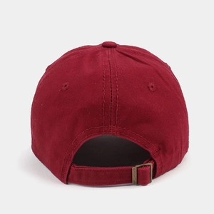 Detail of adjustable metal buckle on cotton baseball cap with ventilation eyelets