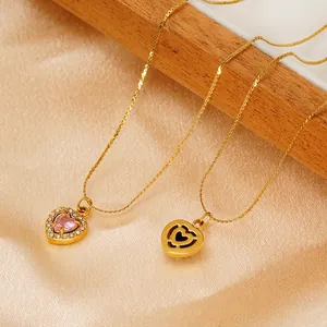 Elegant gold titanium steel necklace with heart-shaped pink zircon pendant on satin backdrop