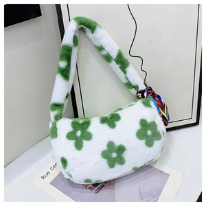 Detail of green floral plush underarm bag featuring a soft faux fur texture and silk scarf