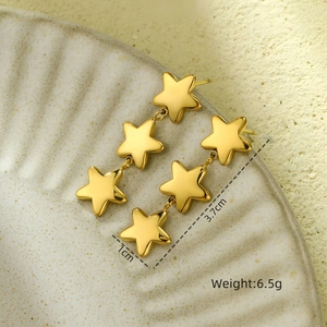 Detail showing 3.7cm long gold star tassel earrings with dimensions on ceramic surface