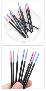 Macro view of nylon fiber bristles on pink, purple, and blue disposable eyelash brushes