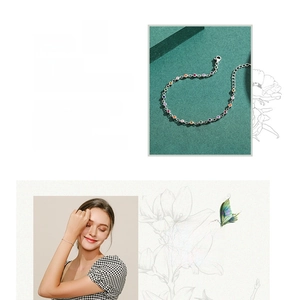 Detail of 925 silver bracelet featuring colorful round candy gemstones on a slim metal chain