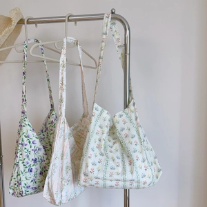 Detailed view of lightweight floral cotton tote bags with wide shoulder straps in various colors