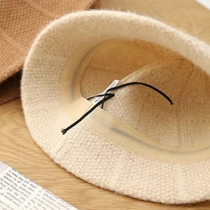 Close-up of knit bucket hat interior showing texture, sweatband and adjustable drawstring