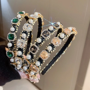 Detail of four hairbands with colorful gemstones and pearls on golden metal frames