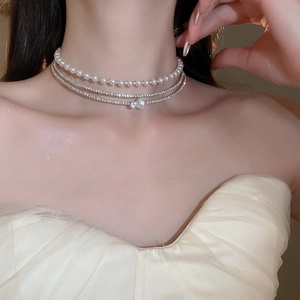 Detail of multi-layer choker featuring white pearls and shimmering silver rhinestones