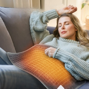 Detailed view of heating pad showing heat distribution on grey knit fabric for pain relief