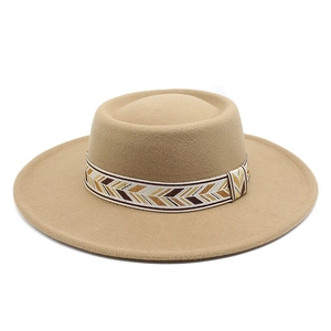 Detail of khaki wool felt flat top hat featuring an ethnic chevron woven band accessory