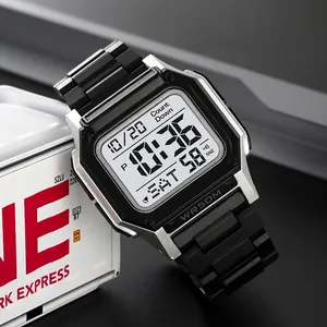 Dual time sport digital watch with silver square case and black resin strap on industrial box