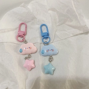Detail of cute cloud and star keychains in pink and blue with metal lobster clasps