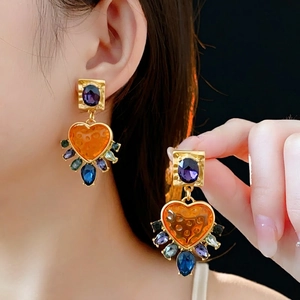 Vintage gold heart earrings with vibrant purple main stone and colorful gemstone accents