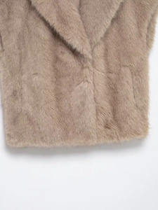 Detailed close-up of faux fur texture and lapel design on the earthy pink warm vest
