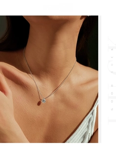 Close-up of S925 sterling silver necklace with a brilliant round moissanite pendant on neck