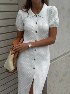 Close-up of white cable knit texture and button detail on a short-sleeve polo dress