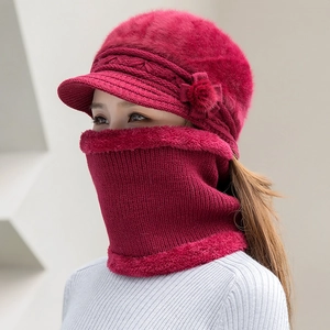 Detail of burgundy knitted hat with plush floral decor and warm fleece-lined neck warmer
