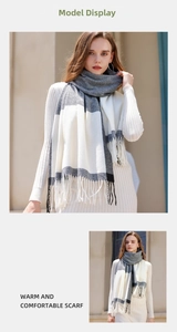 Detail of black and grey plaid scarf with soft tassels and warm cashmere texture
