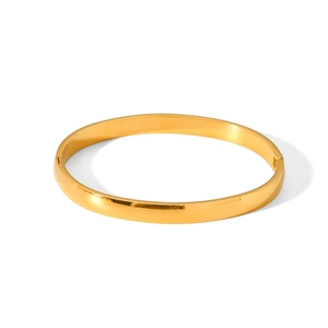 Detailed view of polished gold stainless steel bangle with side hinge and spring clasp