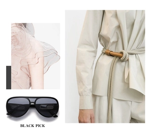 Detail of black oversized aviator sunglasses with classic double bridge and trendy outfit