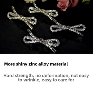 Detailed view of silver and gold alloy bow hair clips encrusted with sparkling rhinestones