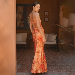 Detail of back view showing the cutout design and orange floral print of the maxi dress