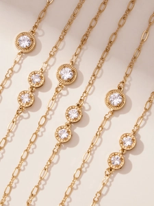 Detail view of 18k gold plated stainless steel sweater chain with sparkling 5A zircon stones