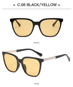 Detail of square vintage sunglasses with black frames, yellow lenses and pearl-set temples