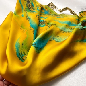 Classic yellow silk scarf featuring traditional Chinese landscape ink painting pattern