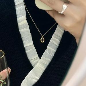 Minimalist stainless steel gold chain necklace with black oval pendant in retro style