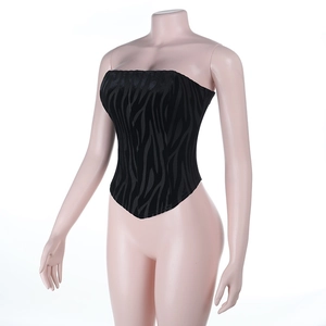 Detail view of black zebra print velvet corset top with a stylish V-shaped hemline