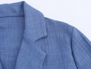 Detail view of the elegant blue blazer notched lapel and shoulder seam tailoring