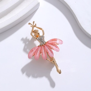 Detail of a gold ballet dancer brooch featuring pink opal petals and sparkling rhinestones