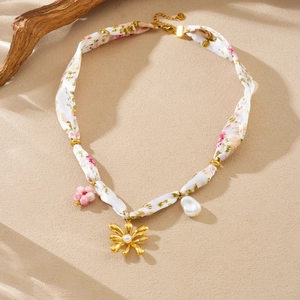 Detail of floral silk ribbon necklace with gold beads, baroque pearl and flower charms