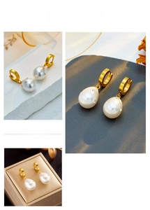 Macro shot of gold teardrop pearl earrings with diamond accents and luxury finish