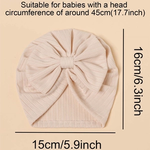 Detail view of pink infant turban hat with large bow and size dimensions shown