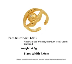 Detailed close-up of eye-shaped gold stainless steel ring with crystal inlay