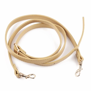 Detail of beige PU leather shoulder strap with gold swivel snap hooks and fine stitching