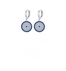 Macro detail of S925 sterling silver evil eye hoop earrings with blue and white crystals
