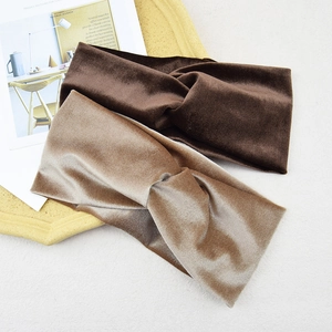 Detailed flat lay of twisted velvet headbands in dark coffee and champagne brown shades