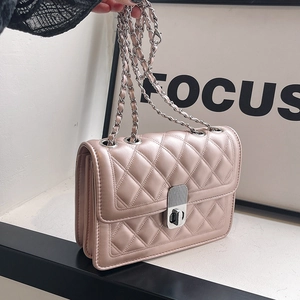 Detail of light pink quilted chain bag with silver twist-lock and crossbody strap