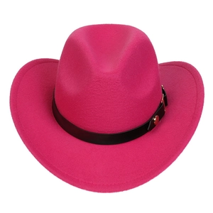 Detail of rose red felt cowboy hat featuring black leather band and gold buckle accents