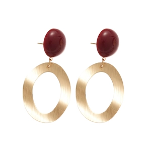 Brushed gold oval earrings with deep red resin studs on a minimalist white background