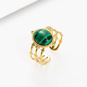 Macro shot of 18K gold plated adjustable ring with oval malachite inlay and branch texture