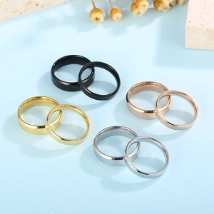Minimalist stainless steel rings in gold, rose gold, silver and black finishes on a blue base