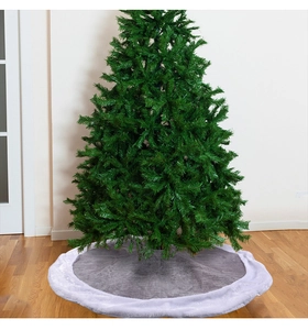 Close-up of gray velvet Christmas tree skirt with plush faux fur trim on wooden floor