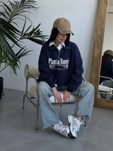 Navy blue half-zip sweatshirt with white letter print in a casual street style
