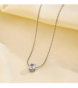 Macro view of silver color O-chain necklace with a sparkling white solitaire pendant