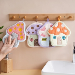 Detail of soft hanging mushroom coral fleece hand towels in a modern bathroom setting