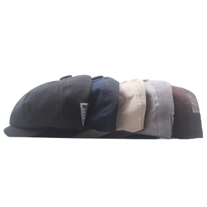 Detail view of various breathable mesh newsboy caps showing diverse color options and textures