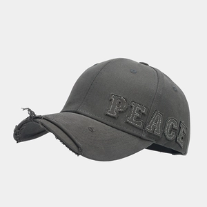 Detail of distressed brim and PEACE letter embroidery on dark grey cotton baseball cap